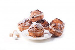 Homemade muffins with brown sugar isolated over white