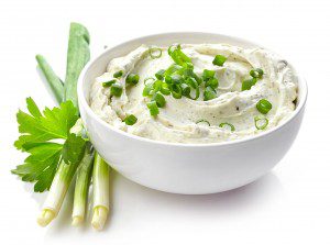 bowl of cream cheese with green onions and herbs, dip sauce isolated on white background